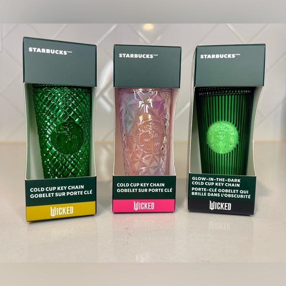 Starbucks New WICKED Inspired Merchandise is Thrillifying  Starbucks Wicked Elphaba, Glinda, Emerald
City Keychain Set of 3